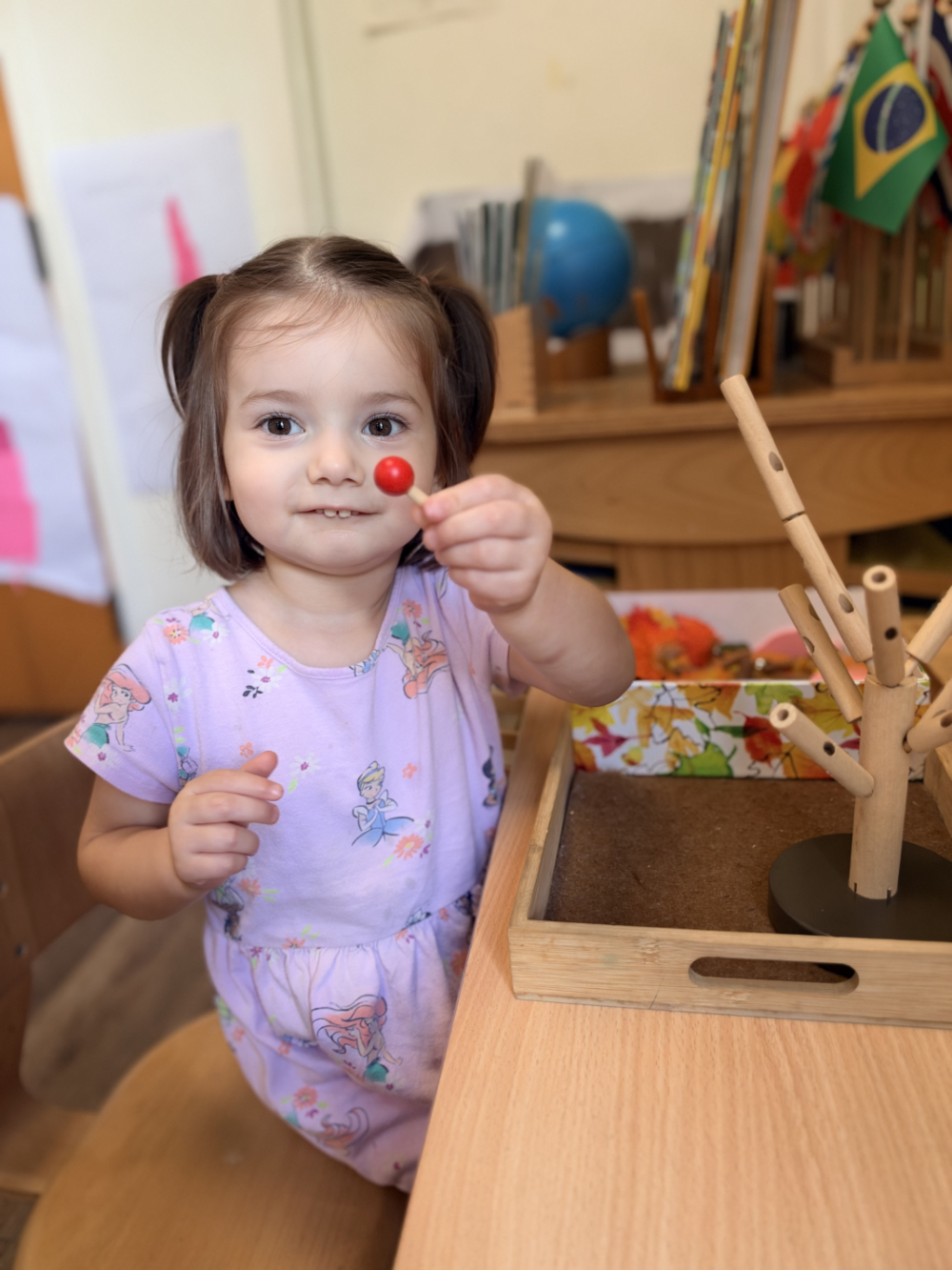 Child concentrating on a Montessori-based sewing project
